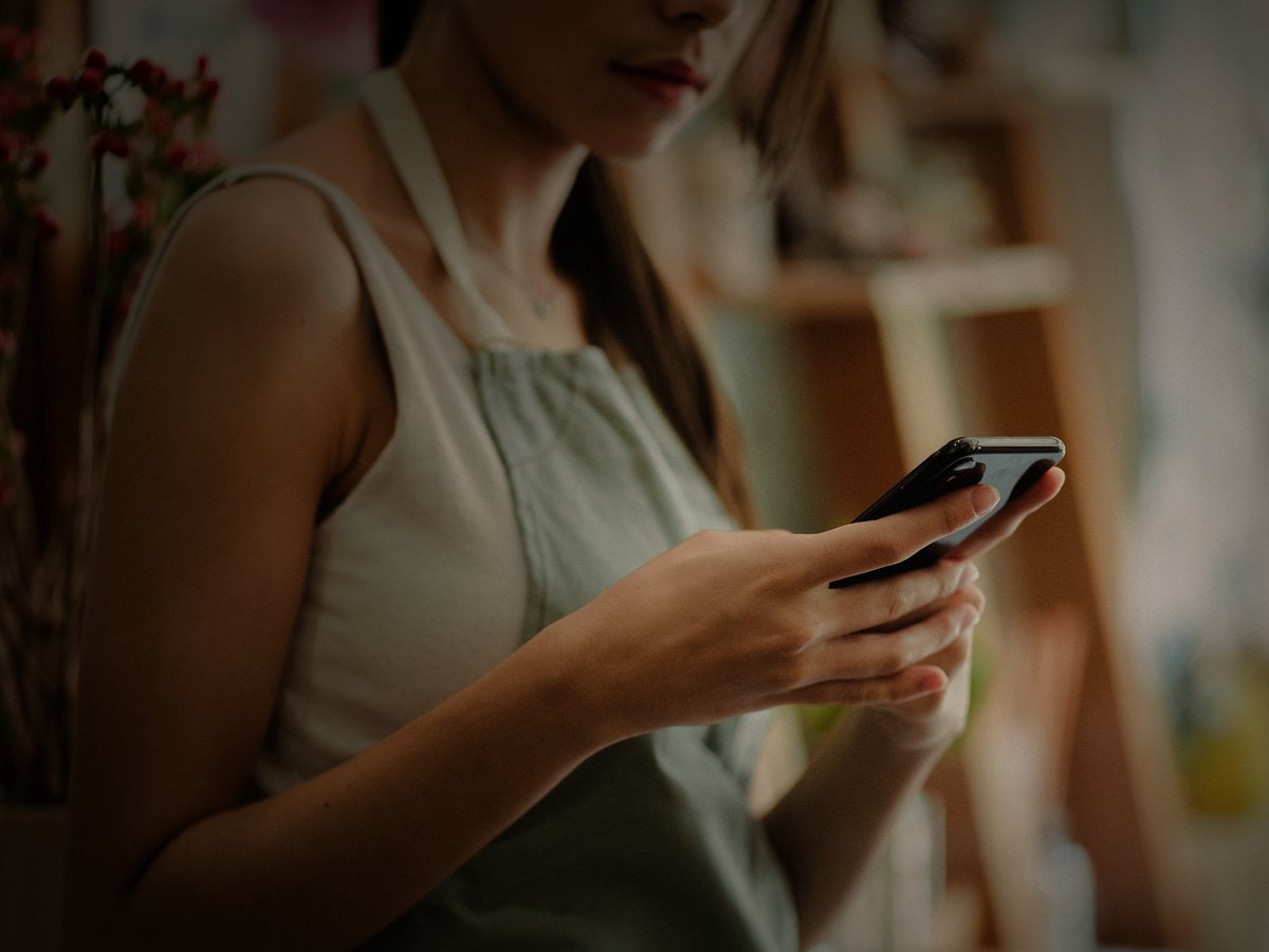 A shop owner on her phone after closing